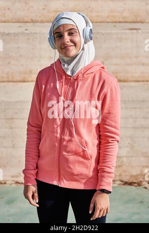Young muslim sportswoman in hijab standing Stock Photo