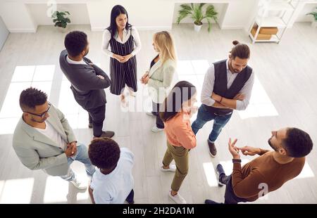 Groups of multiracial people communicating during business event or psychological training Stock Photo
