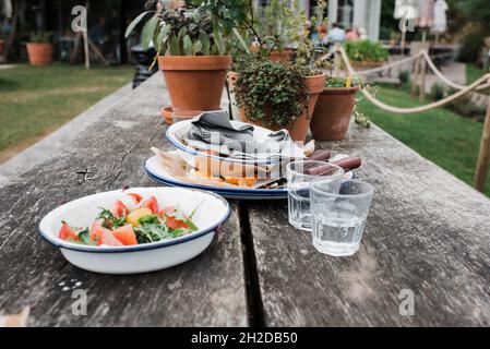 finished dishes stacked on an outdoor table at a restaurant Stock Photo