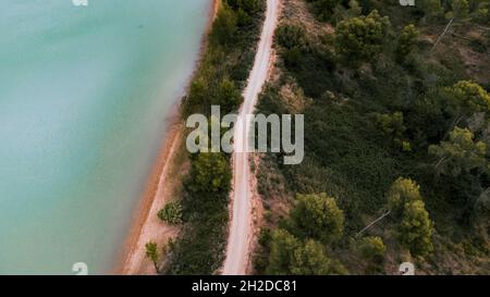 Aerial view of a lake next to a pine trees Stock Photo - Alamy