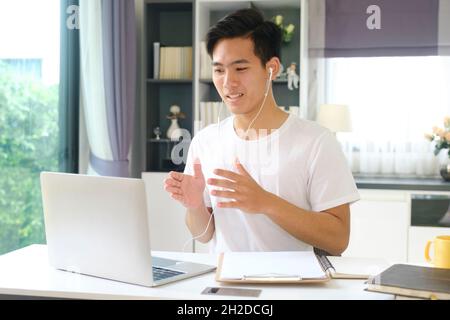 Young man working and studying online at home. Online working and Online learning. Stock Photo