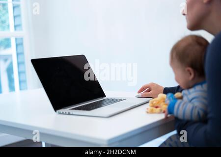 working mother with holding the baby on lap Stock Photo