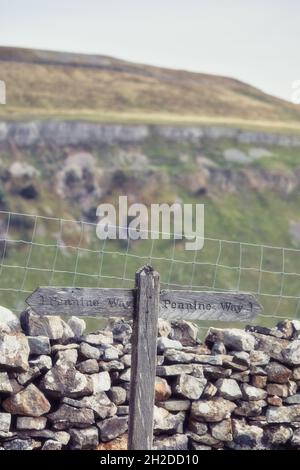 Rustic wooden directional Pennine Way sign for hikers walkers, Swaledale, Yorkshire Dales National Park, Richmondshire, North Yorkshire, England Stock Photo