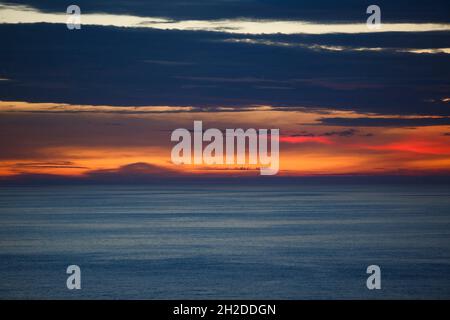 orange sunset clouds over the ocean Stock Photo