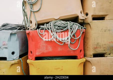 Heaps of assorted plastic boxes with ropes and dirty surface in harbor of Iceland Stock Photo