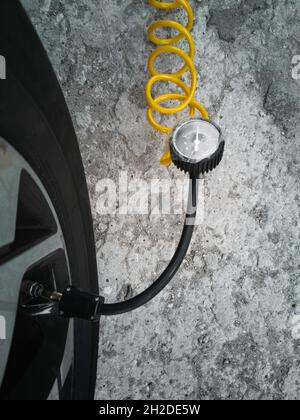 There is a compressor for inflating tires near the car Stock Photo