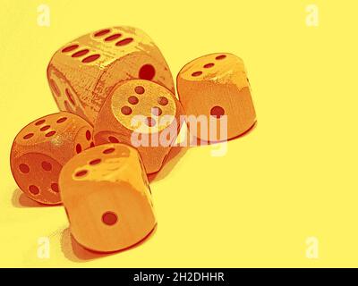 Game dice in front of a yellow background Stock Photo