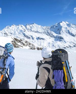 High alpine adventure on glacier in tirol mountains - ski mountaineerers on the way up to Wilder Pfaff Stock Photo