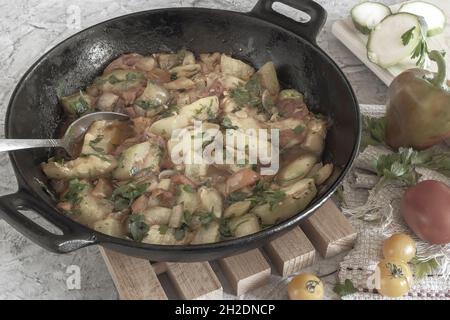 Delicious fried zucchini in a cast-iron frying pan Stock Photo