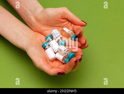 Female medical worker holding coronavirus vaccines in her hands without gloves Stock Photo