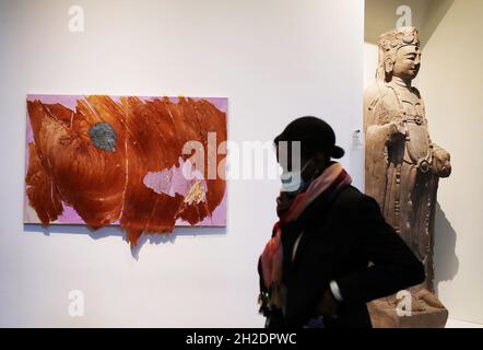 Paris, France. 21st Oct, 2021. A visitor walks past a piece of artwork titled 'Made of the same wood' by Vietnamese artist Thu-Van Tran at the 'L'Asie Maintenant' exhibition at the Guimet National Museum of Asian art in Paris, France, Oct. 21, 2021. Credit: Gao Jing/Xinhua/Alamy Live News Stock Photo