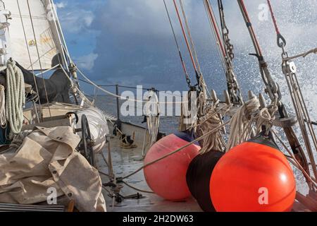 Rigging, fenders and coiled ropes on deck of sailing ship in the Caribbean Sea Stock Photo