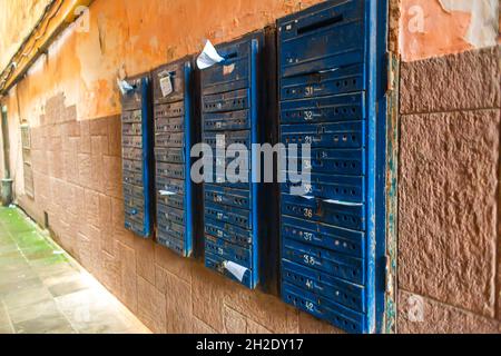 A wall with rows of mailboxes in a multi-storey residential building. Stock Photo