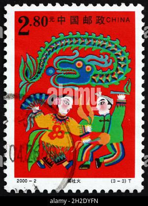 CHINA, PEOPLE’S REPUBLIC OF - CIRCA 2000: a stamp printed in the China shows offering sacrifices to god of land, spring festival, circa 2000 Stock Photo
