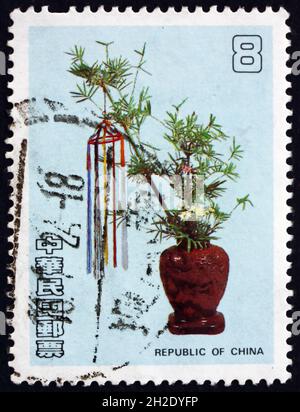 CHINA - CIRCA 1987: a stamp printed in the China shows flower arrangement in brown vase, circa 1987 Stock Photo