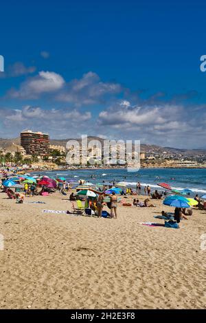 Spain.Beautiful sunny day on the beach in El Campello with visible apartment buildings by the sea in the distance.Vertical view Stock Photo