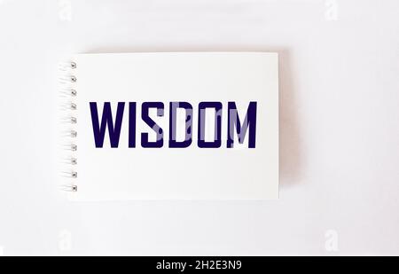 Wisdom word written on notepad and white background Stock Photo