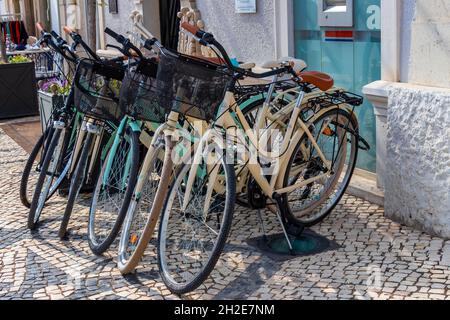 Vila Real de Santo António, Portugal - October 12, 2021: A lot of old bicycles parked in line on the sidewalk Stock Photo