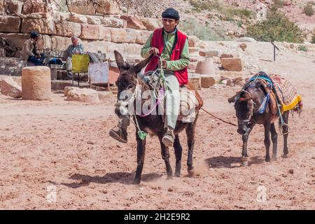 PETRA, JORDAN - MARCH 23, 2017: Local donkey rider in the ancient city Petra, Jordan Stock Photo