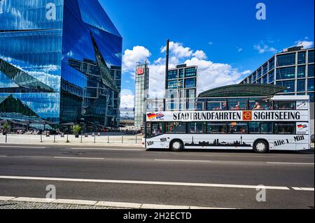 Berlin, Germany - July 29, 2021: Hop on hop off bus near the Hauptbahnhof in downtown Berlin. At the left side you can see the Cube Berlin. Stock Photo