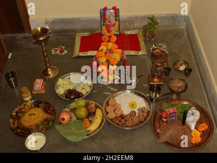Lakshmi Pooja festival being celebrated at an Indian Bengali home in India. Laxmi is also known as Goddess of wealth Stock Photo
