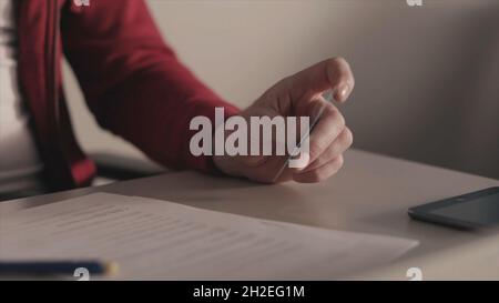 Online payments concept. Stock. Business man holds a credit card in his hand while using or typing identification numbers after buying goods from reta Stock Photo