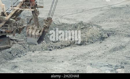 Close-up of mining excavator scooped up the ore with a bucket. Quarry mining equipment Stock Photo