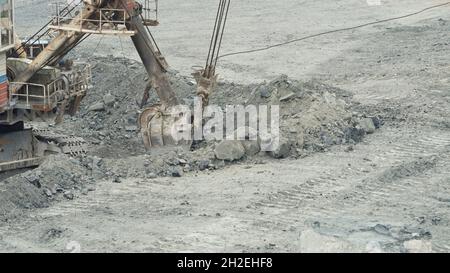 Close-up of mining excavator scooped up the ore with a bucket. Quarry mining equipment Stock Photo