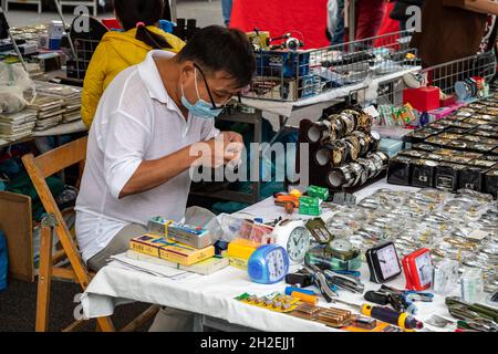 Street vendor selling clocks and watches at Mercato di Porta Portese street market in Trastevere district of Rome, Italy Stock Photo