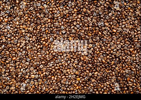 Roasted espresso or coffee beans background. Colorful table top view. Stock Photo