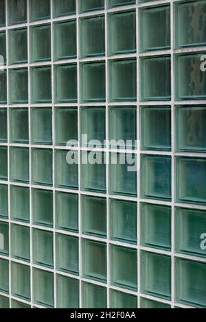glass bricks used for letting in light in a modern building, glass building bricks, glass cubes, glass square bricks, lines, rows, patterns, structure Stock Photo