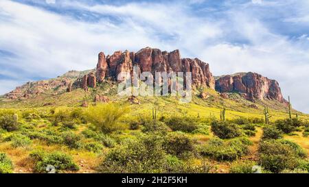 Flatiron Peak from Lost Dutchman State Park on Sunny Spring Day. Superstition Mountains from Treasure Loop Trail with yellow brittlebush and saguaro. Stock Photo