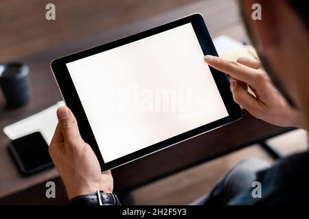 Digital tablet device white screen in male hand over tablet mockup image Stock Photo