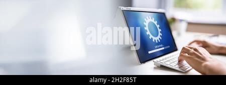 Hybrid Man Software Online Update. Laptop OS Stock Photo