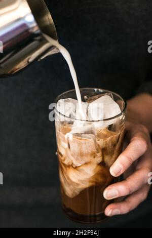 Mom making iced coffee to drink for breakfast Stock Photo