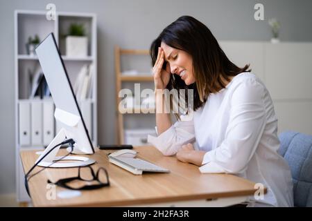 Stressful Business Woman Working On Computer In Office Stock Photo