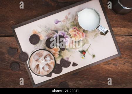 Iced coffee flat lay photo with milk and chocolate on wood background Stock Photo