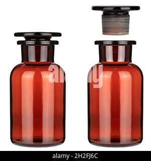 Closed medical bottle of brown color glass. Glass jars with chemicals. Open and closed two bottle. Stock Photo