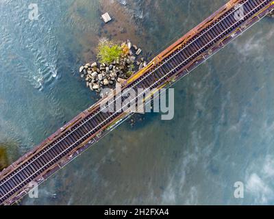 Top down view of railroad trestle over Catawba River in South Carolina, USA with mist rising from water. Stock Photo