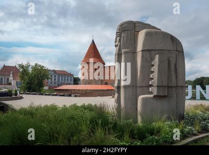 Kanklininkas Sculpture (created by Robertas Antinis in 1968) with Kaunas Castle on background - Kaunas, Lithuania Stock Photo