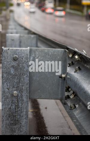 underscrewed nuts and bolts in highway road railing Stock Photo