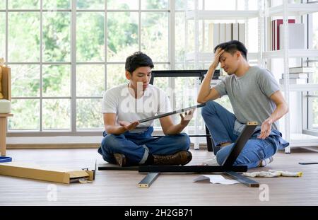 House renovation service. Two carpenters discussed the type of bench being assembled. Morning work atmosphere in the living room. Handyman installing Stock Photo