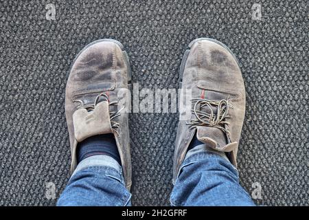 New trainers on a man wearing blue jeans Stock Photo - Alamy