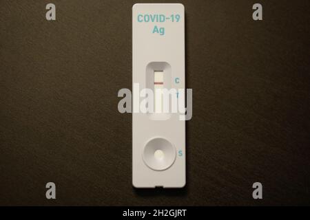 Shallow depth of field (selective focus) image with a COVID-19 Antigen Rapid Test, with the result negative. Stock Photo