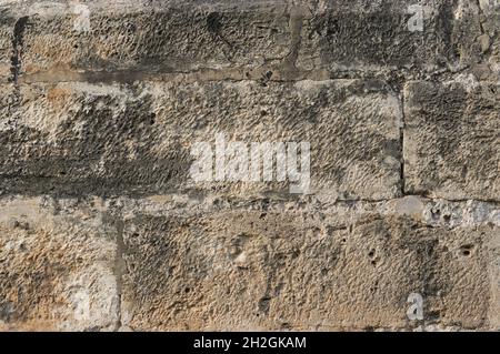 brown old wall on detail of large pieces of stone as bricks rectangular gray background Stock Photo