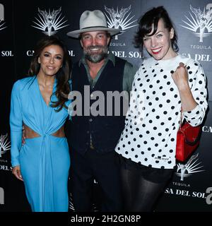 LOS ANGELES, CALIFORNIA, USA - OCTOBER 21: Actress Eva Longoria Baston, photographer Brian Bowen Smith and actress Milla Jovovich arrive at Brian Bowen Smith's Drivebys Book Launch And Gallery Viewing Presented By Casa Del Sol Tequila held at 8175 Melrose Ave on October 21, 2021 in Los Angeles, California, United States. (Photo by Xavier Collin/Image Press Agency) Stock Photo
