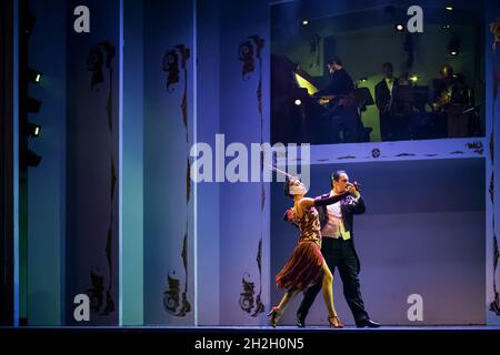 Horizontal shot of a couple of dancers in a tango performance, with Astor Piazzola music, in the historic Café de los Angelitos, Buenos Aires Stock Photo