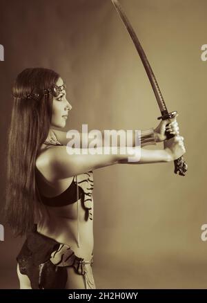 young warrior woman holding sword in her hand Stock Photo