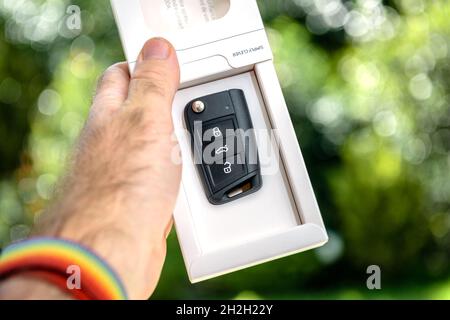 ale hand giving offering the new car key for the Skoda Electric car Stock Photo