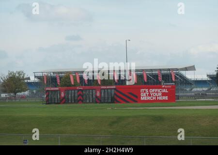 Silverstone museum Northamptonshire UK stands seats seating outside building sign signs flag flags cover weather rain raining metal building light Stock Photo